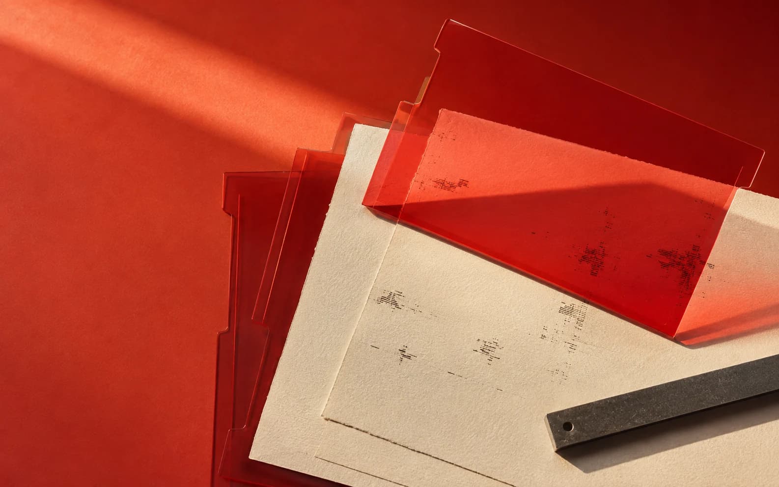 Conceptual artwork: red evidence sleeves reveal layers of ivory paper.